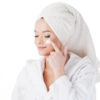 Portrait of a young beautiful woman in a Terry robe and with a towel on her head. Beauty and skin care